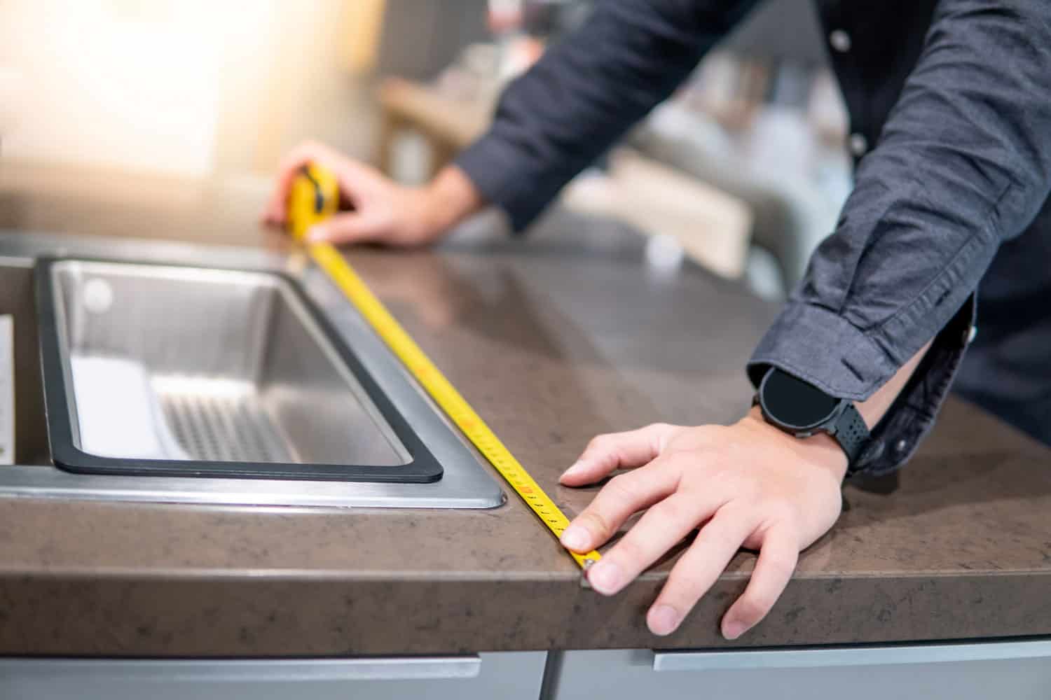 A-male-hand-measuring-the-kitchen-countertop