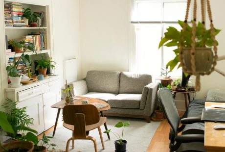 gray fabric loveseat near brown wooden table