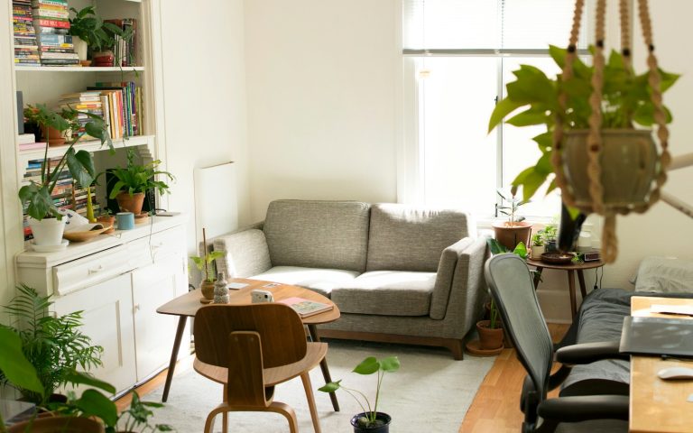 gray fabric loveseat near brown wooden table