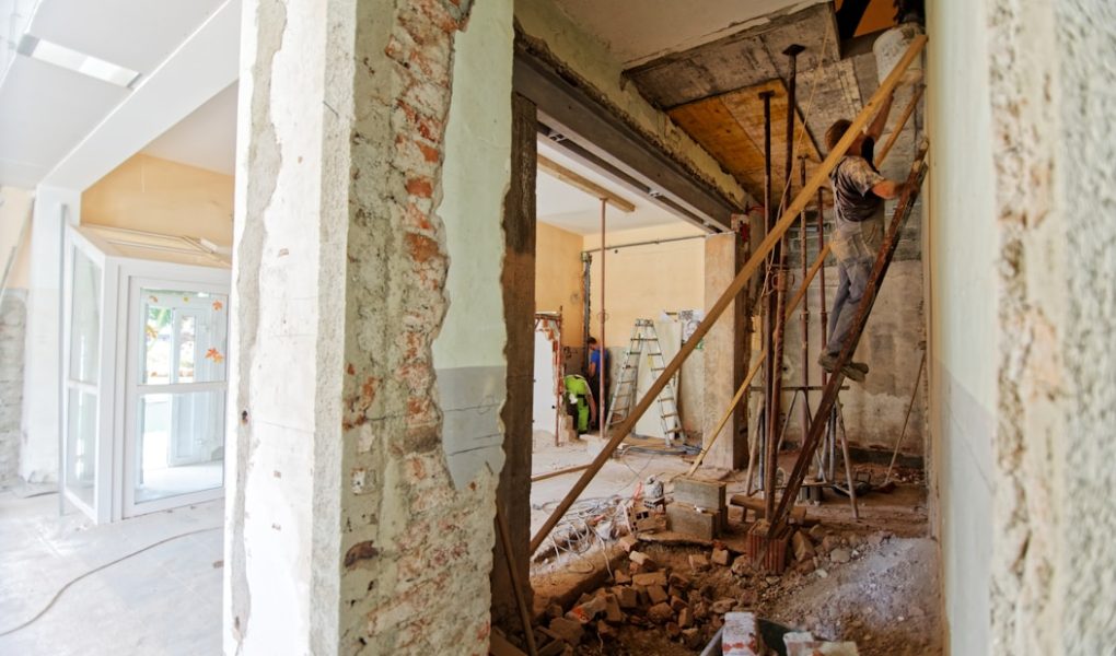 man climbing on ladder inside room