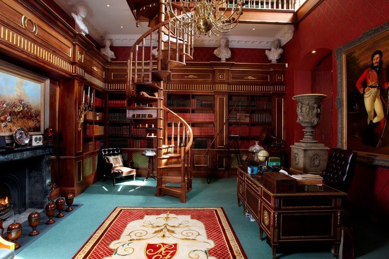 Castlehyde House library with spiral wooden staircase and mahogany bookshelves