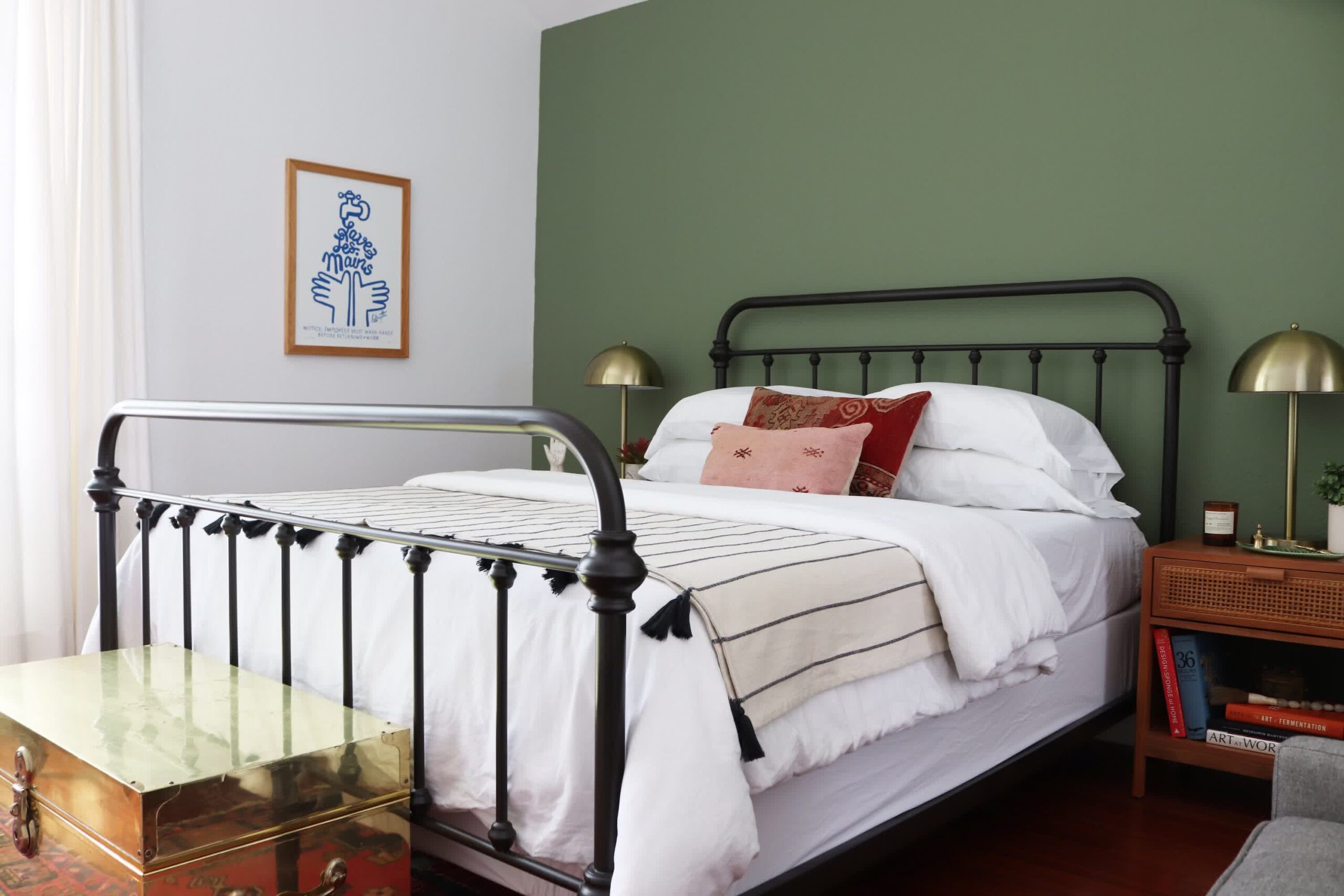 Dark green wainscoting below warm white upper walls in a traditional bedroom setting