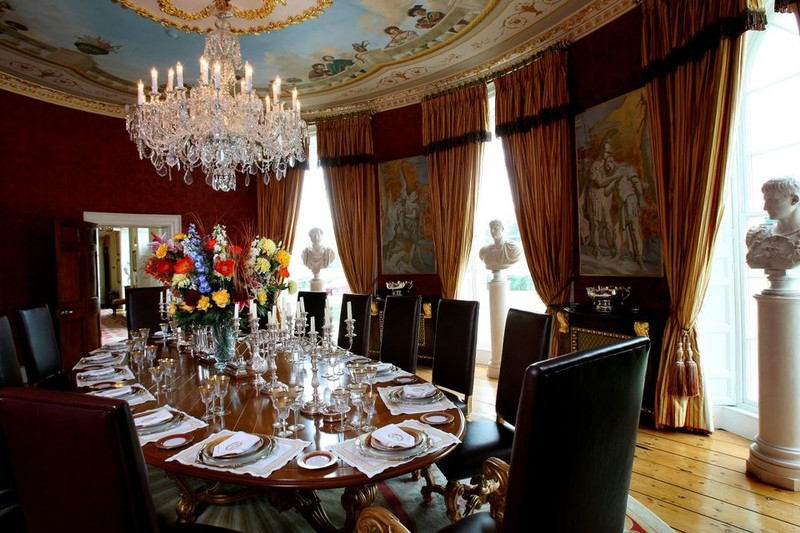 Grand dining room in Castlehyde with fresco ceiling, crystal chandelier and ornate table setting