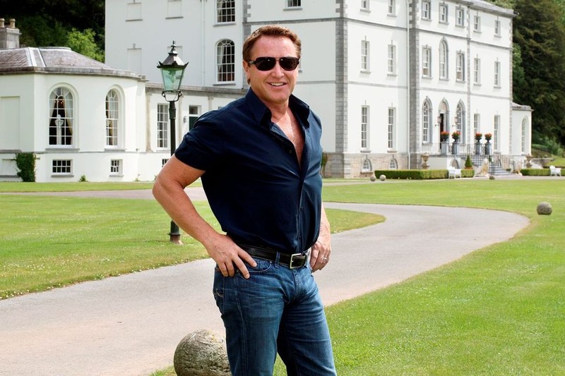 Michael Flatley stands before the exterior of Castlehyde House in Cork, Ireland