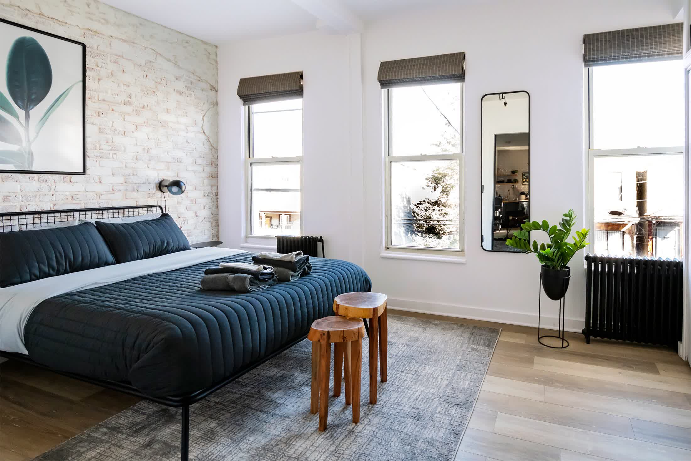 Minimalist green bedroom with flush-built furniture and clean uncluttered surfaces