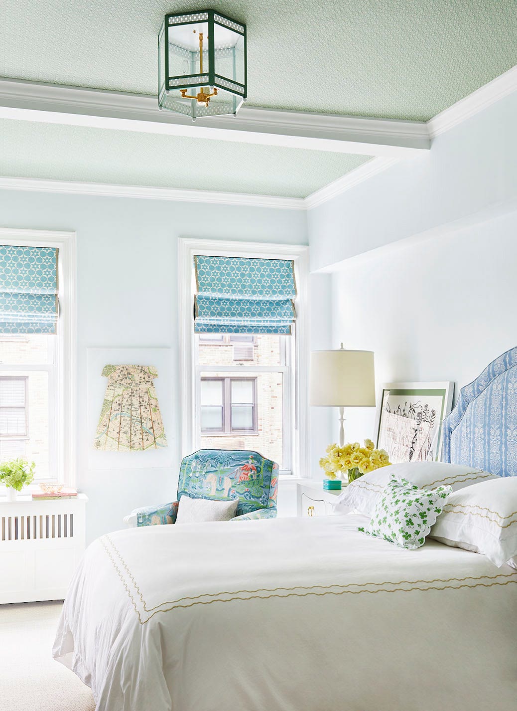 Moody green bedroom with warm directional lighting casting a soft glow on dark walls