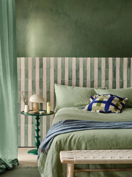 Olive green bedroom with terracotta pots, warm textiles, and earthy Mediterranean accents