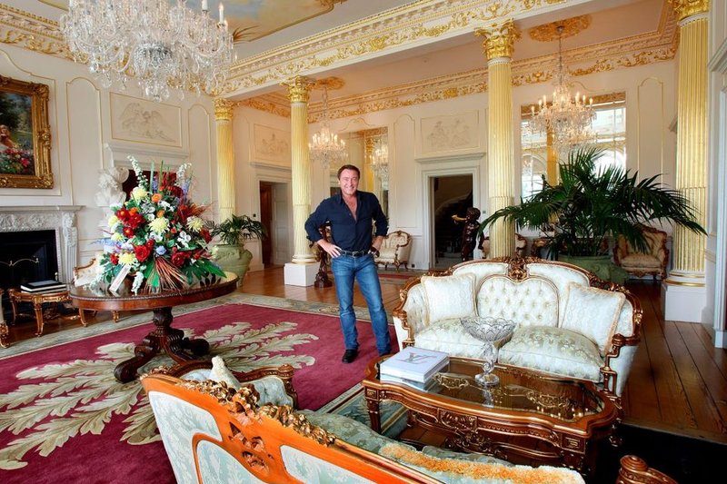 Opulent ballroom inside Castlehyde House featuring gilded columns and crystal chandeliers
