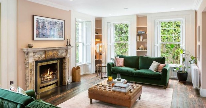 Saoirse Ronan living room with emerald velvet couches and marble fireplace at Pine Lodge Greystones