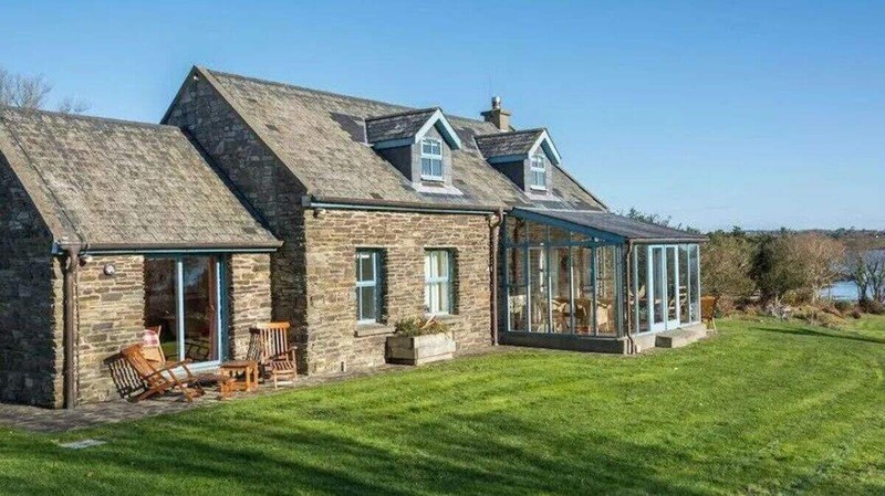 Saoirse Ronan West Cork stone cottage exterior in Ballydehob with dormer windows and surrounding greenery